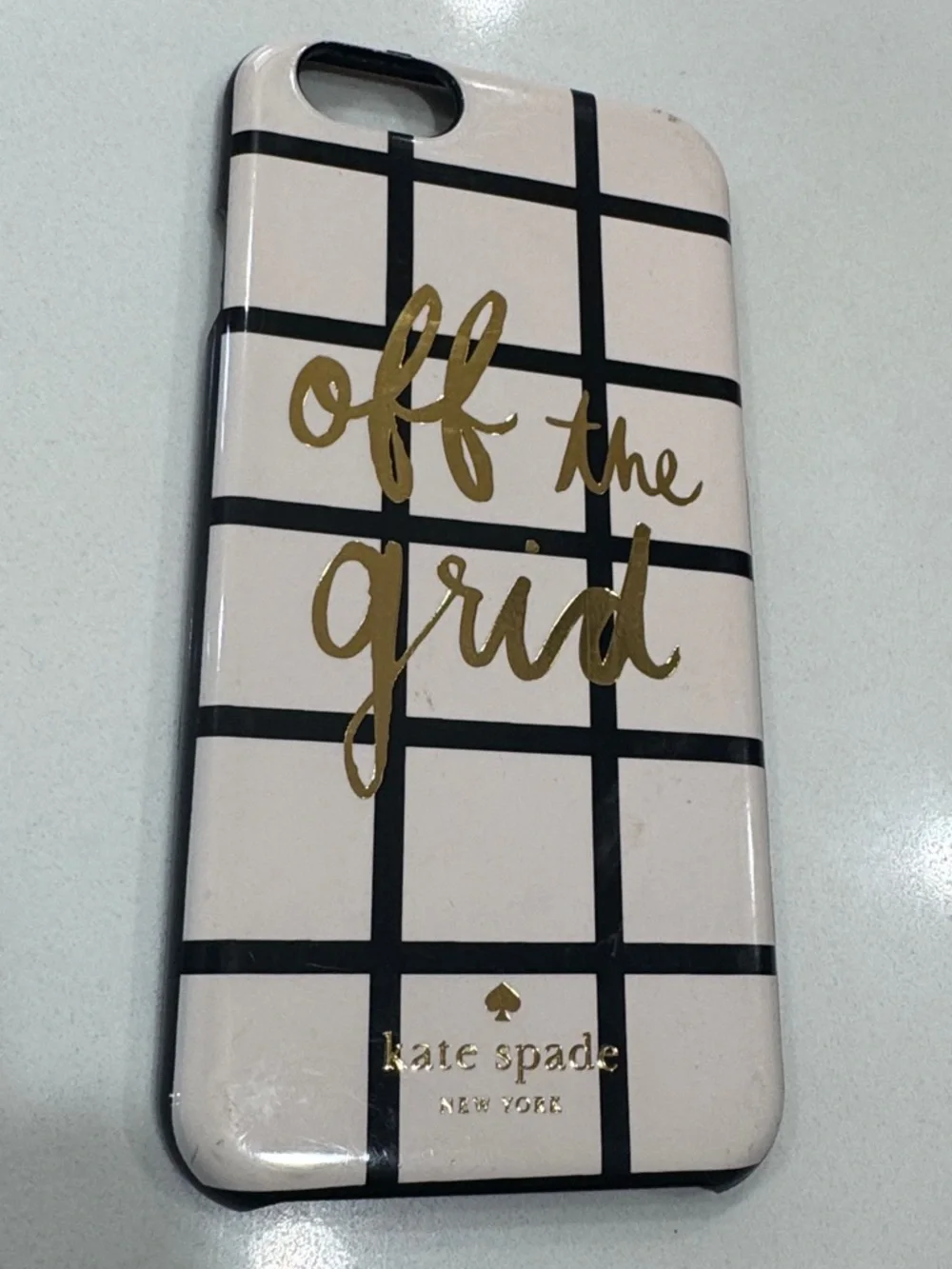 kate spade cream phone case with black grid and gold foil script